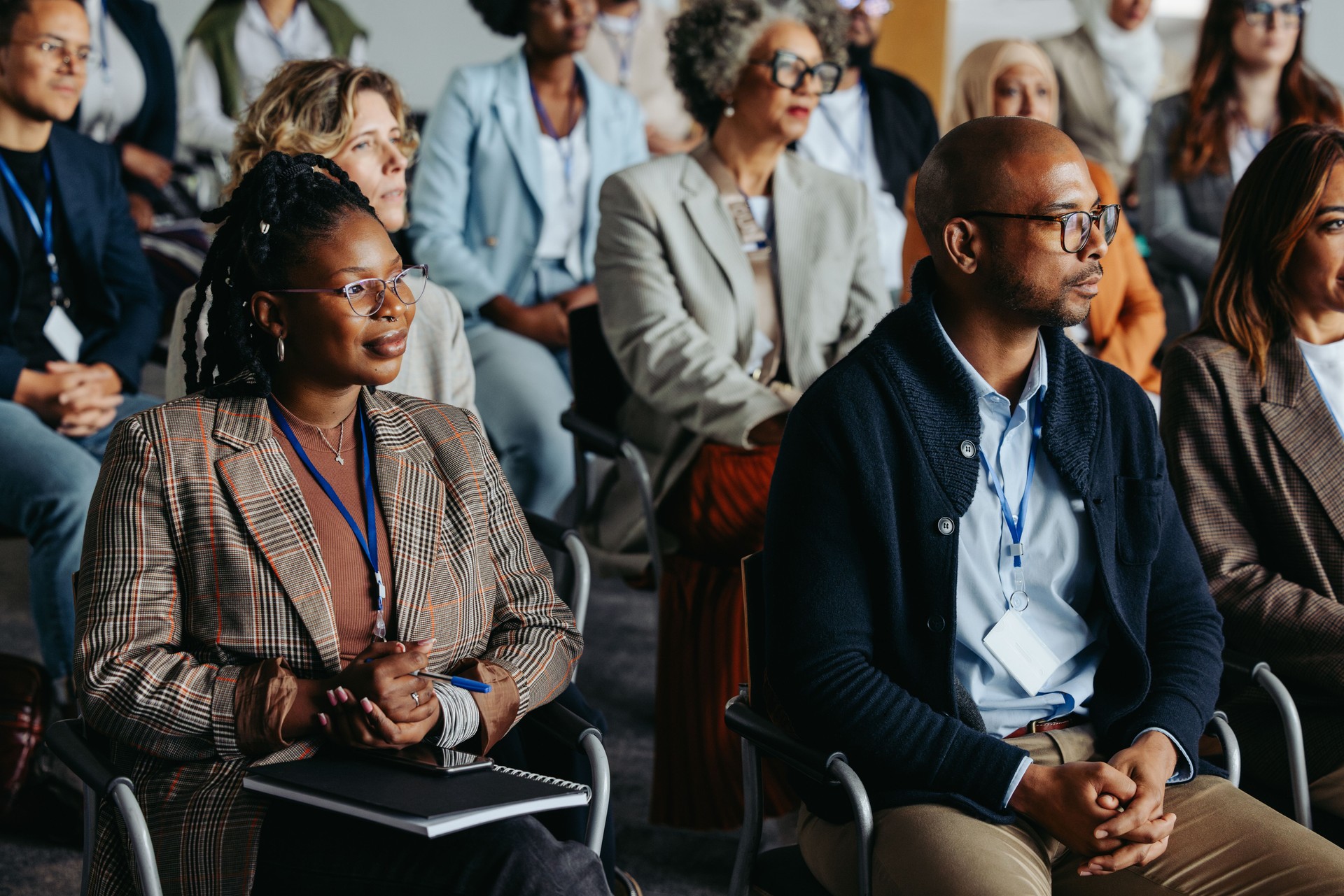 Diverse business audience sitting attentively in a workshop or conference setting